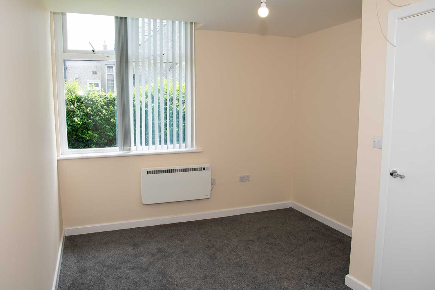 empty room with gray carpet and one window