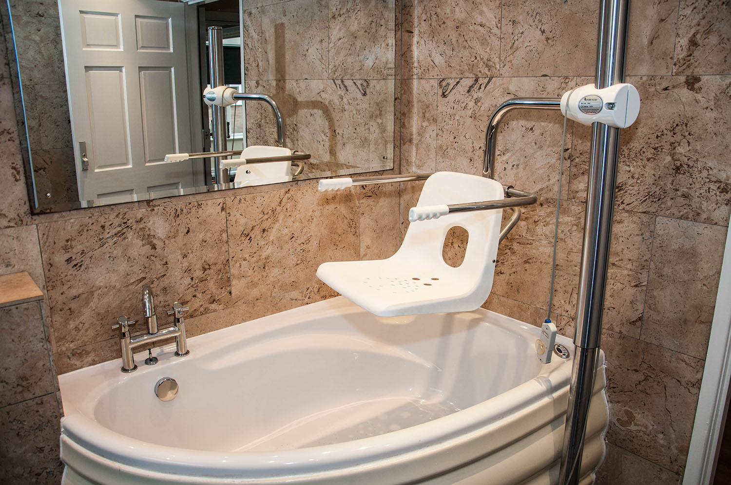 Bath with a chair and a large mirror above