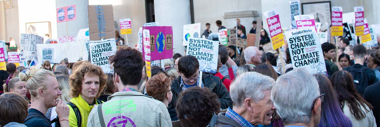 People standing at a protest holding signs